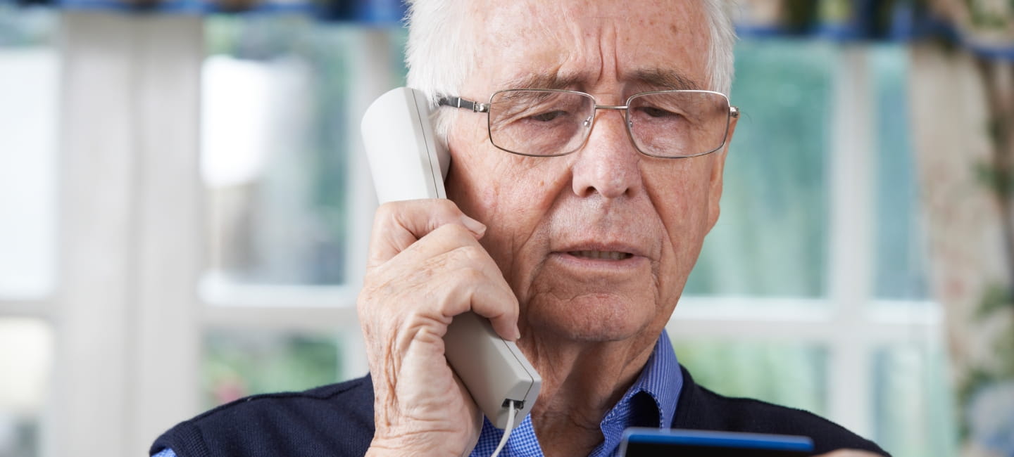Senior Man Giving Credit Card Details On The Phone