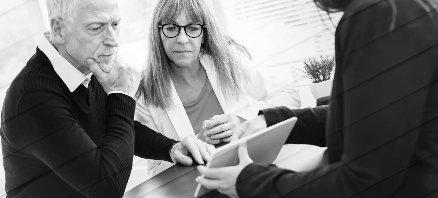 Senior couple meeting financial adviser for investment, geometric pattern