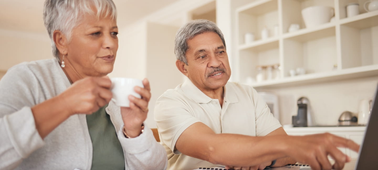 Senior couple, budget and laptop in home for planning loan, investment or financial administration. Man, woman and finance at computer for retirement, savings and banking of insurance, pension or tax
