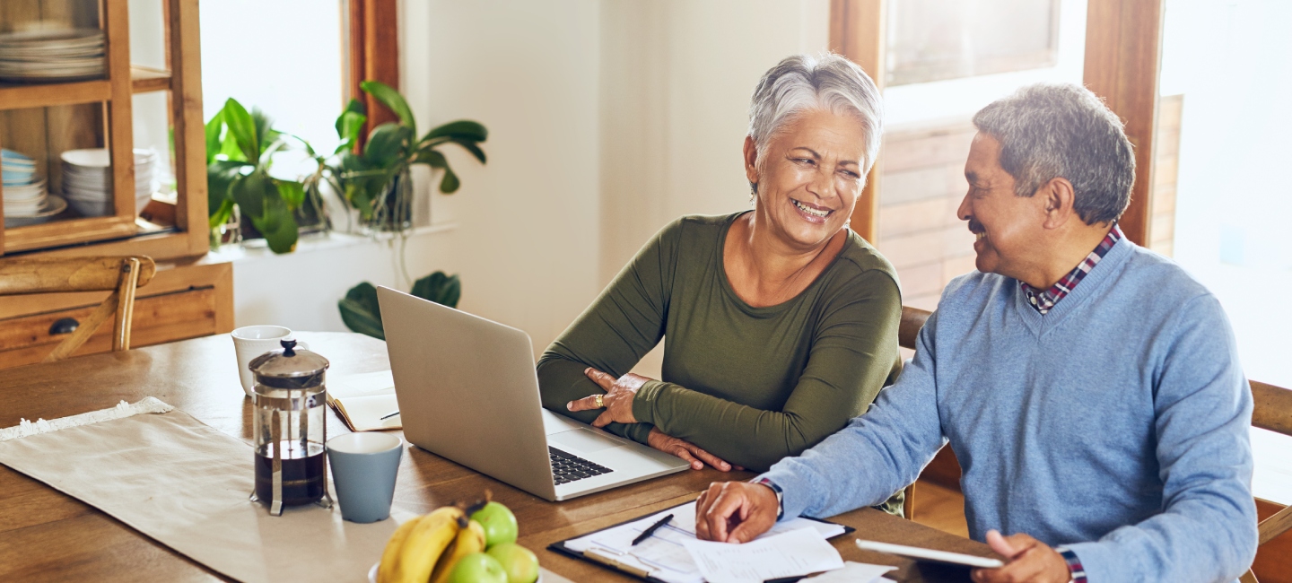 Finance, laptop and happy senior couple with bills, paperwork and documents for life insurance. Retirement, pension and elderly man and woman on computer for mortgage payment, investment and budget