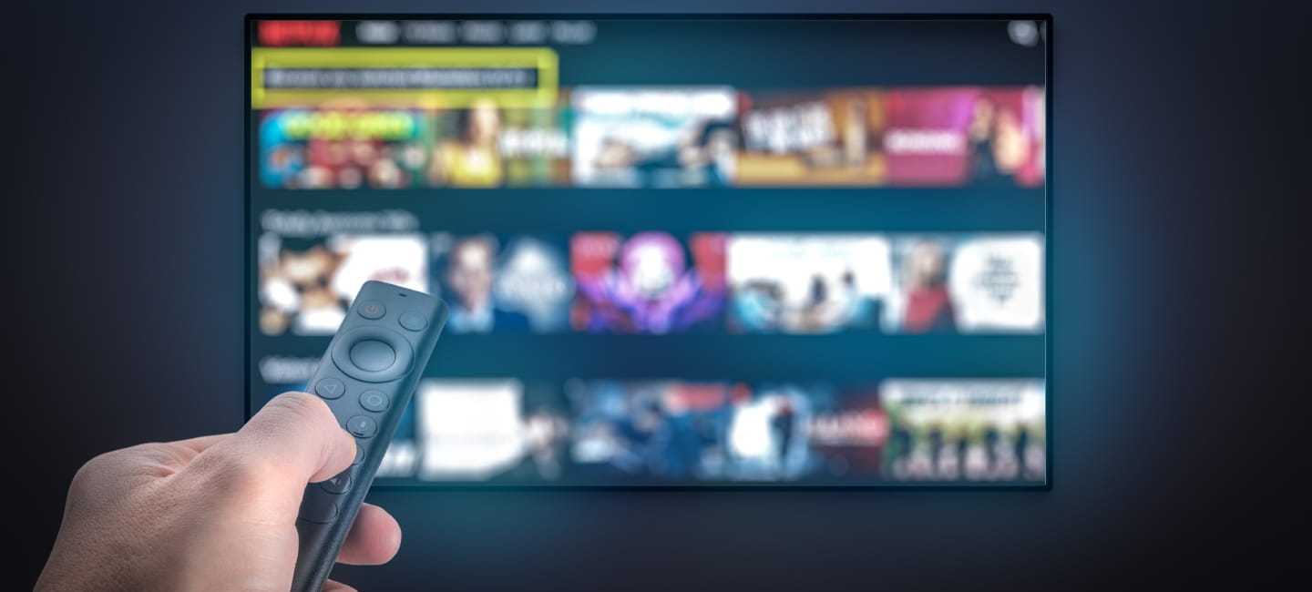 Streaming service. TV screen with lot of pictures and hand holding TV remote control. Multimedia Television video streaming, Media TV on demand. Subscription Streaming video