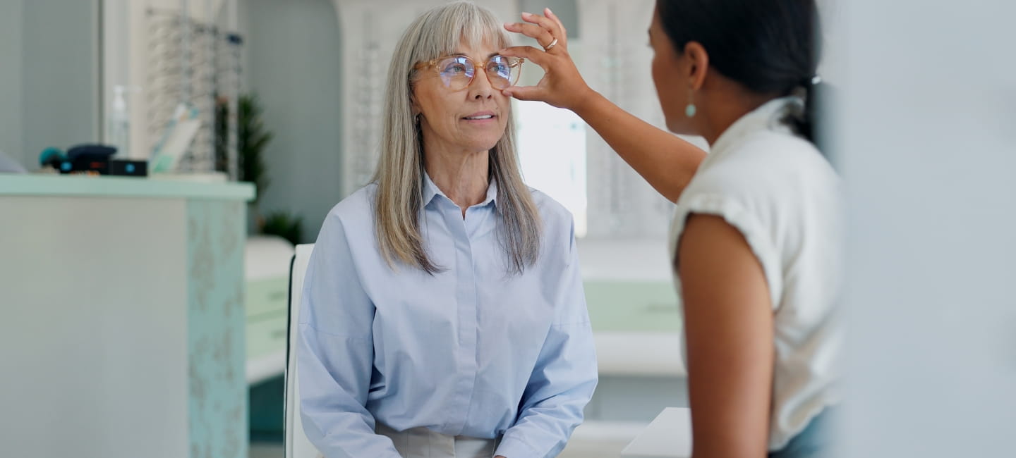 Mature woman, optometrist and glasses retail for shopping consultation for frame size, assessment or prescription. Female person, eye care and sight store with optician advice, spectacles or lens.