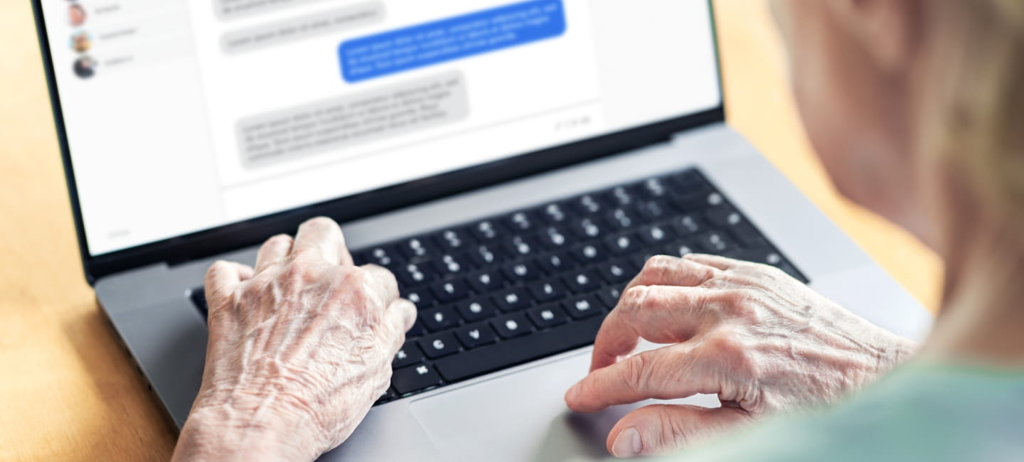 Chat messages in laptop of an old woman. Love fraud scam of catfish. Elder person in online conversation with family. Grandma group messaging. Communication in social media. Customer support chatbot.