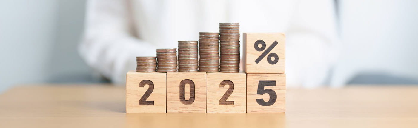 2025 year placed in wooden blocks with percentage and coins stack