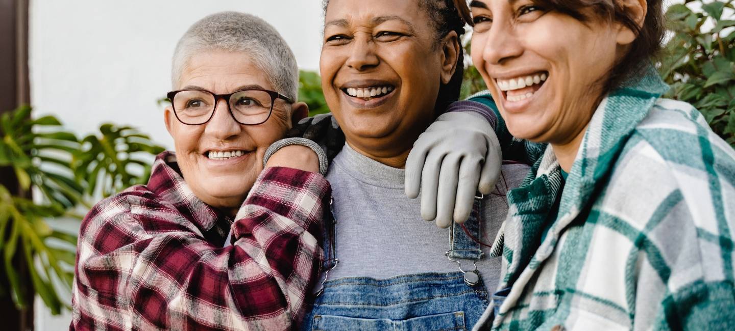 Multiracial senior women gardening outdoor in home backyard terrace