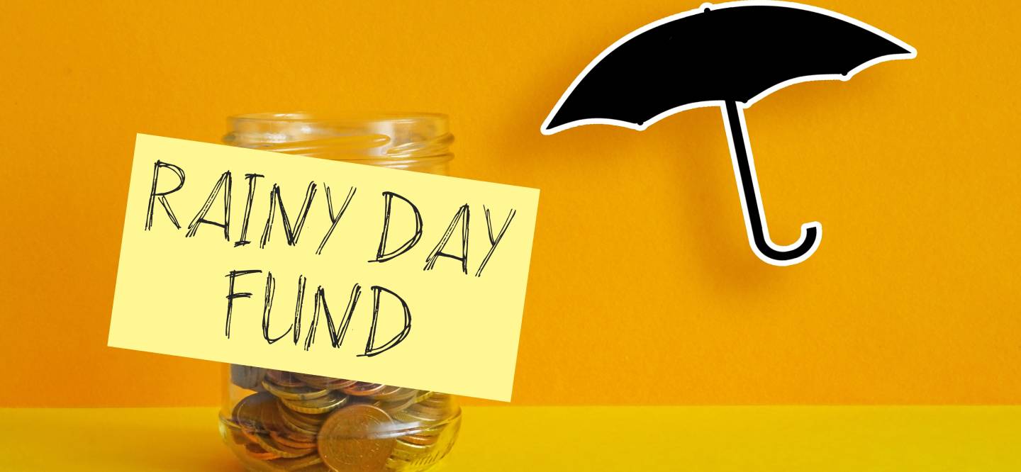 A jar of copper coins, on an orange back ground, with a cut out image of a black umbrella, next to the jar. 