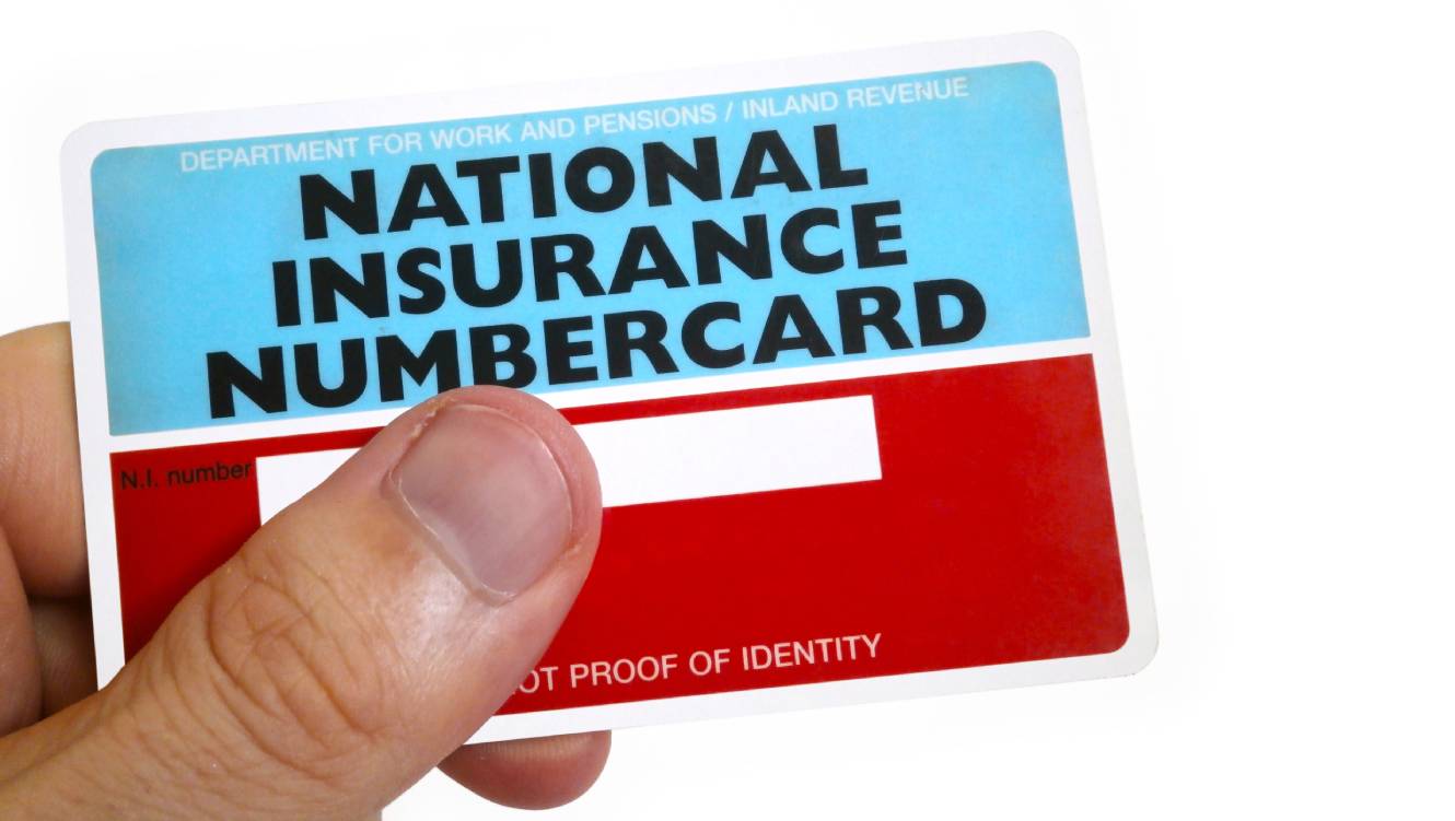Fingers of a man holding a National Insurance Number Card