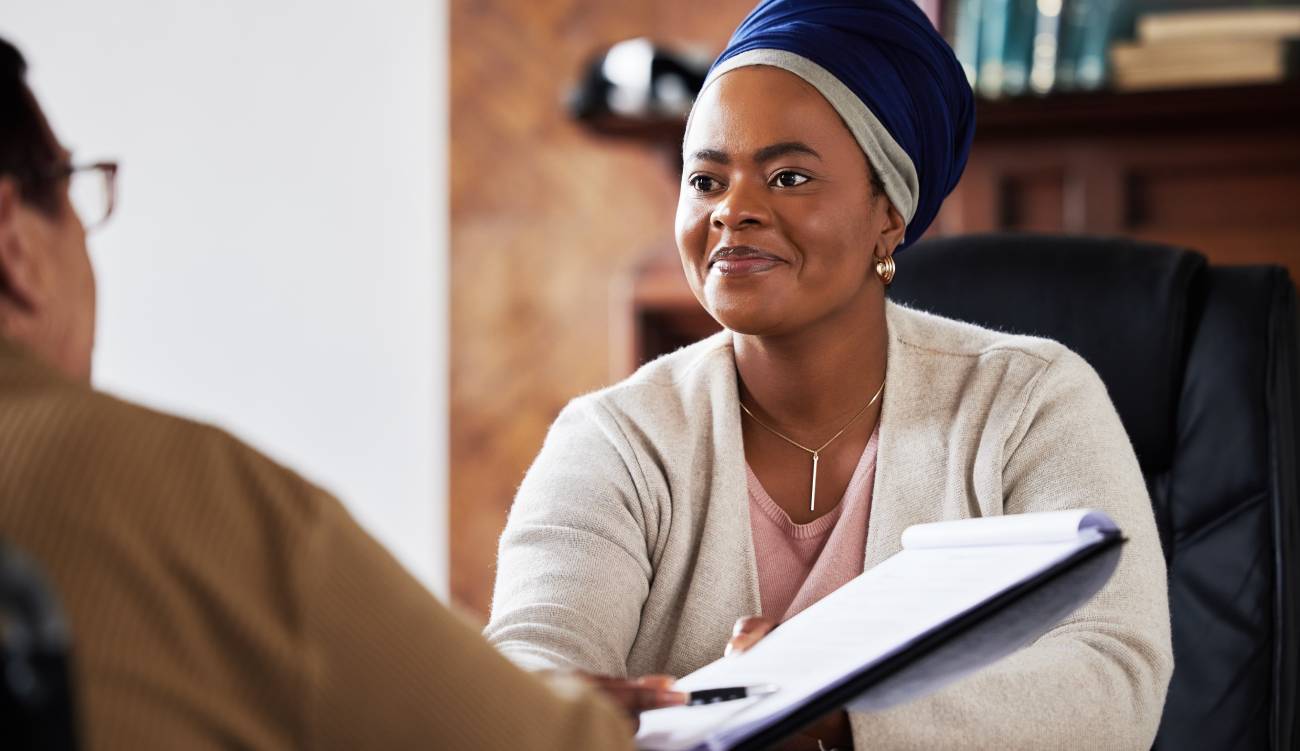 Signature, insurance or legal black woman with senior planning on documents for contract, loan or agreement. Lawyer, financial advisor and consulting with elderly for retirement deal will review