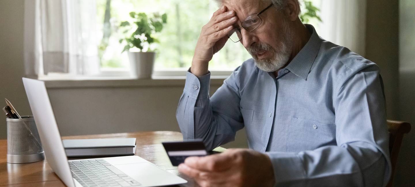 Upset senior aged man worried about finance safety data, online payment security