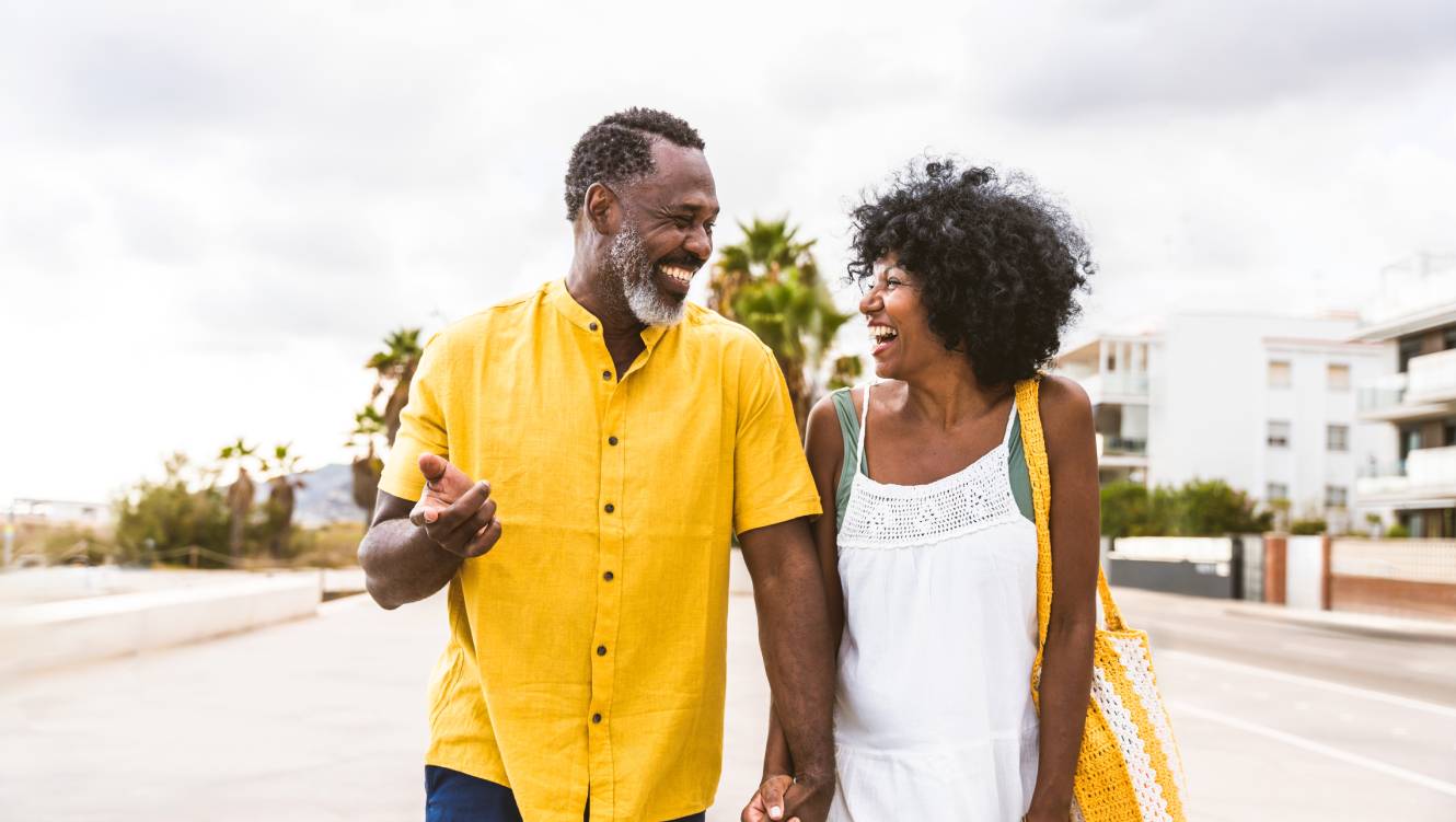 Beautiful mature black couple of lovers dating at the seaside - Married african middle-aged couple bonding and having fun outdoors, concepts about relationship, lifestyle and quality of life