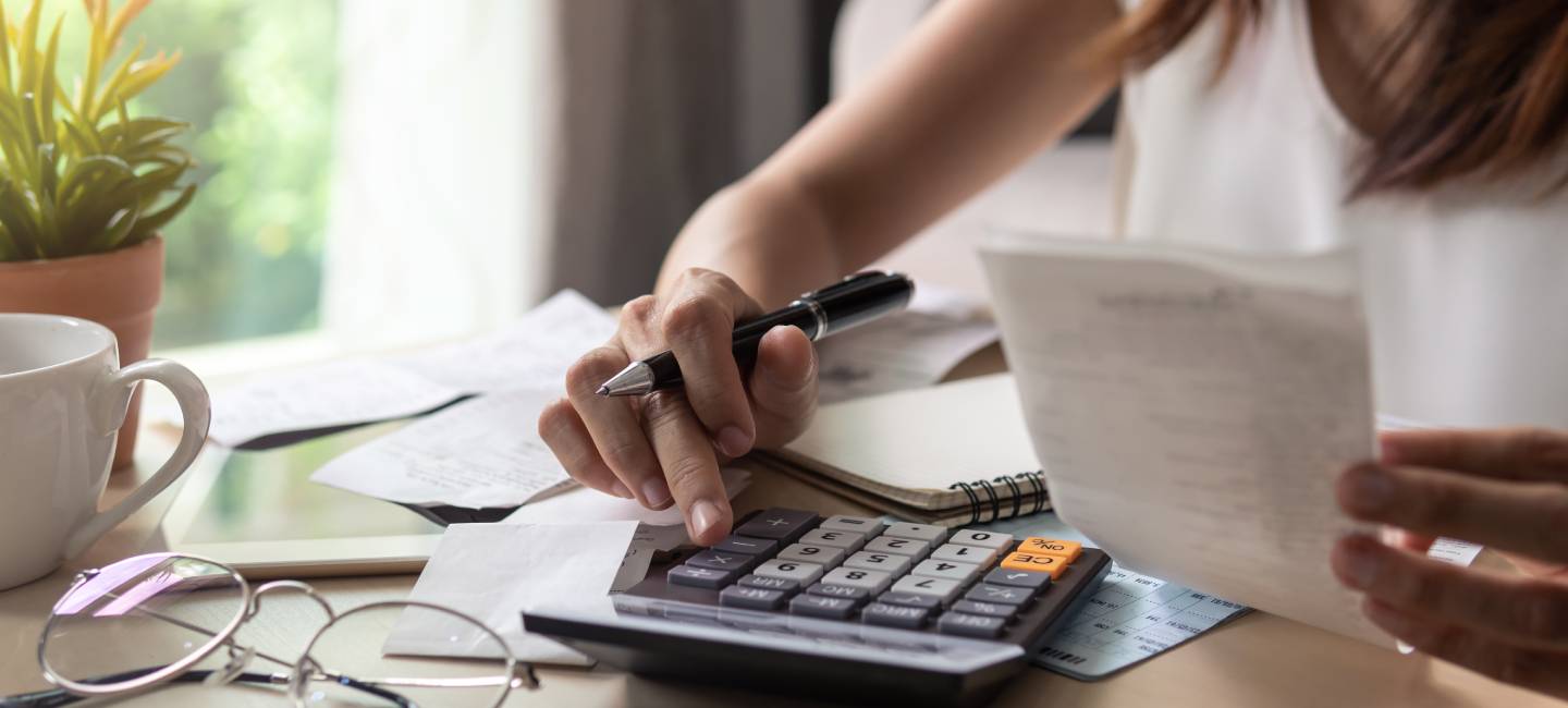Stressed woman calculating monthly home expenses, tax, bank account balance and credit card bills payment, Income is not enough for expenses.