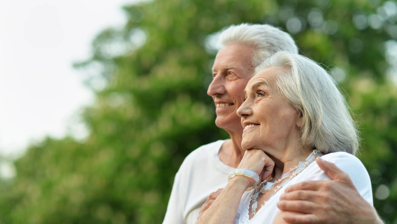 Portrait of beautiful senior couple posing in the park