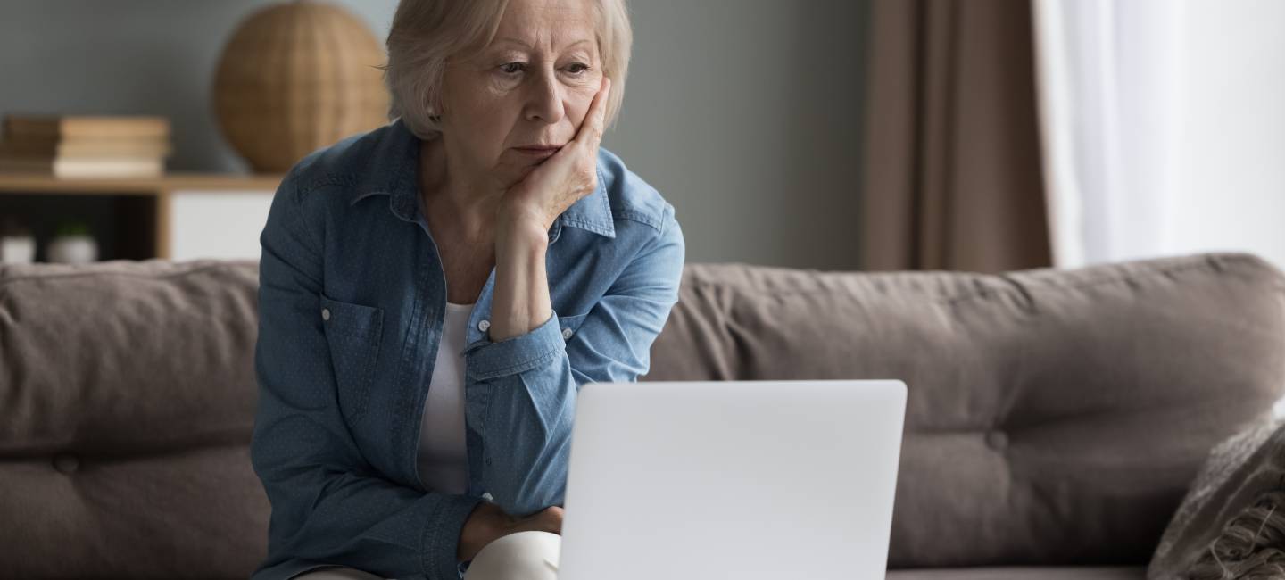 Mature woman looking at her laptop managing financing 