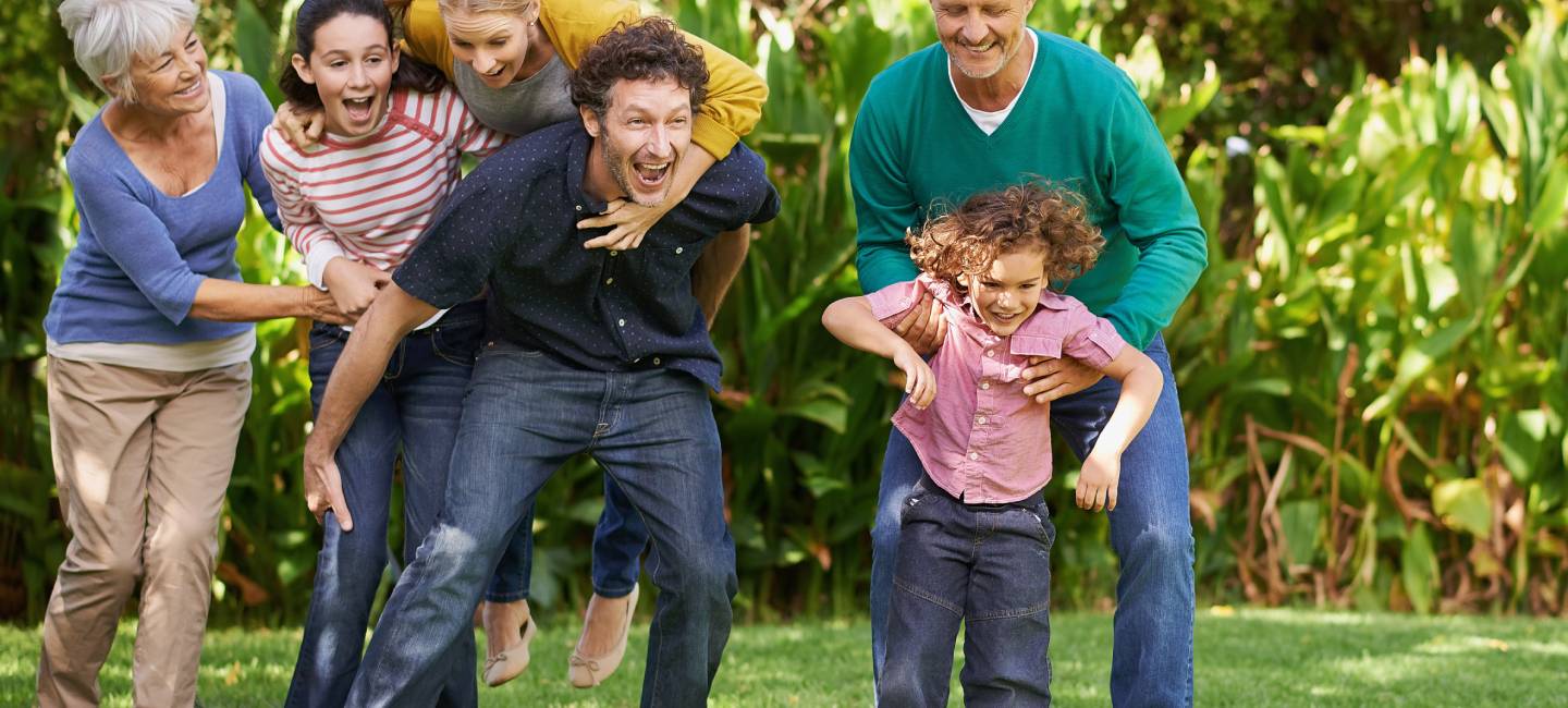 "Happy generational family playing in outdoor nature, love and bonding together