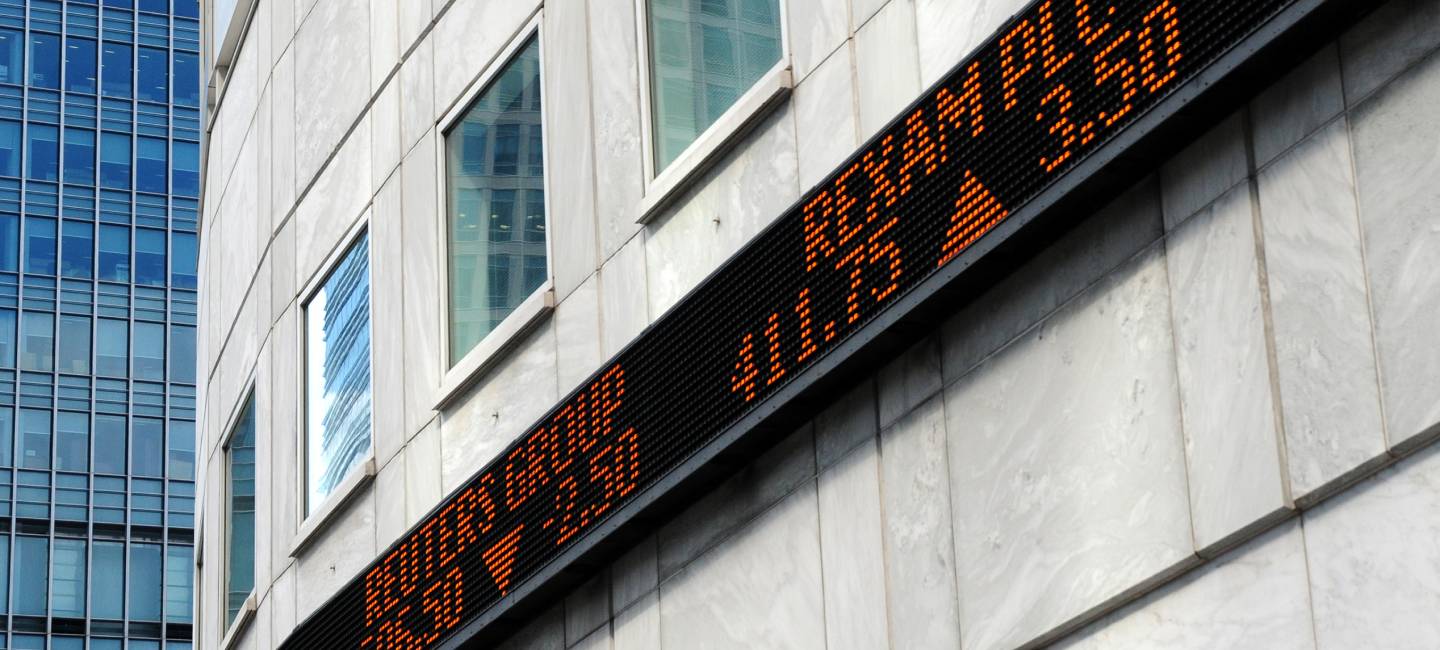Financial market tickertape board outside city of London building