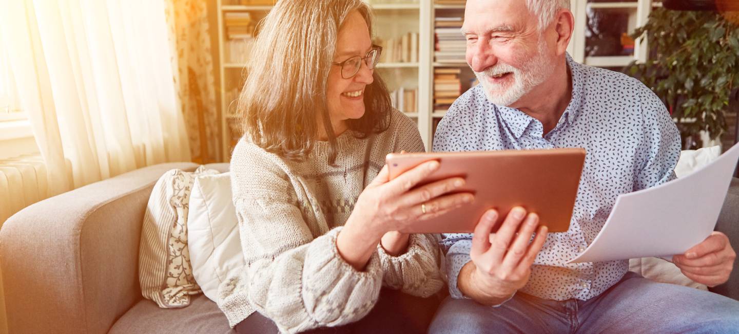 Couple of seniors planning pension investment as retirement provision at home on the tablet computer