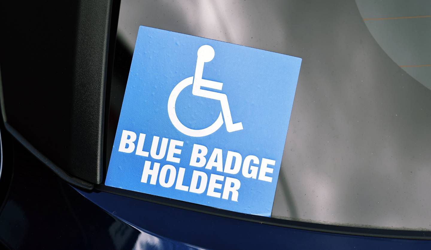 blue badge sticker on a car windscreen