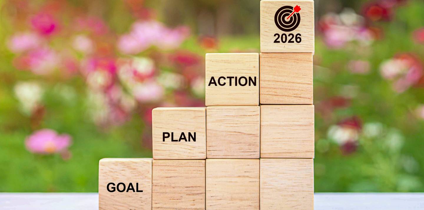 Wooden blocks with the words goal, plan, action and 2026 stacked  next together 