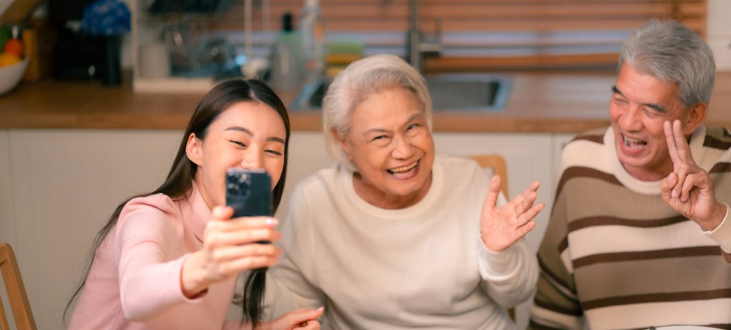 Senior grandparents with grandchild, eating dinner and taking pictures with their grandchild 