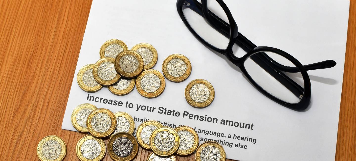 British one pound coins ona an anonymous letter about an increase to the State Pension in the UK