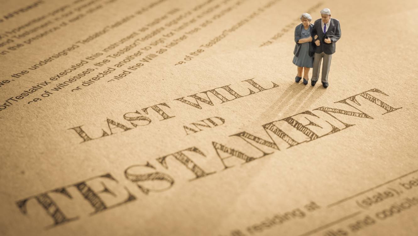Miniature elder / old couple stands on a legal document form, depicts preparing to transfer properties to their heirs after death