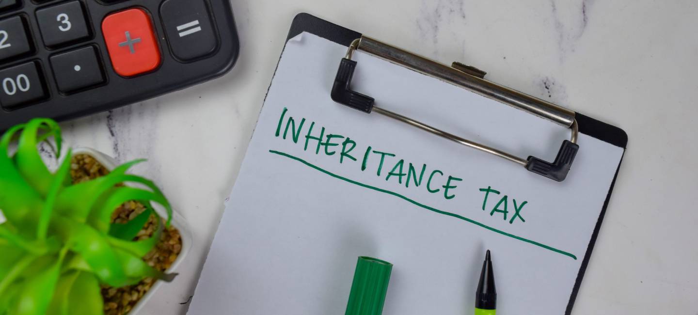 Inheritance Tax write on a paperwork isolated on Wooden Table. medical concept