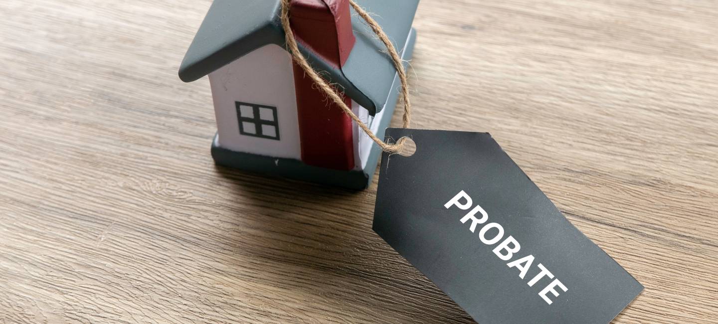Probate Process Concept with House Model and Legal Tag for Estate Settlement