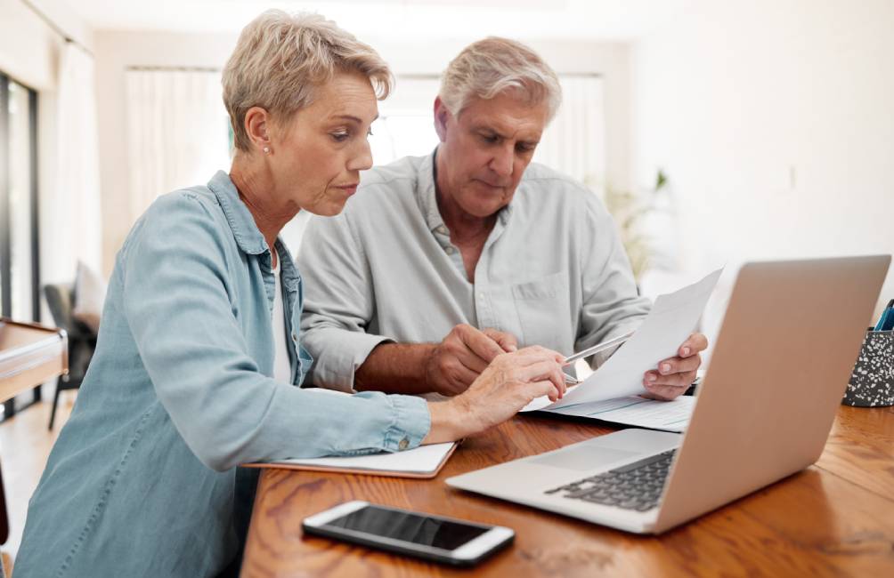 Senior man and woman with documents review finance expenses, retirement plan or mortgage banking payment