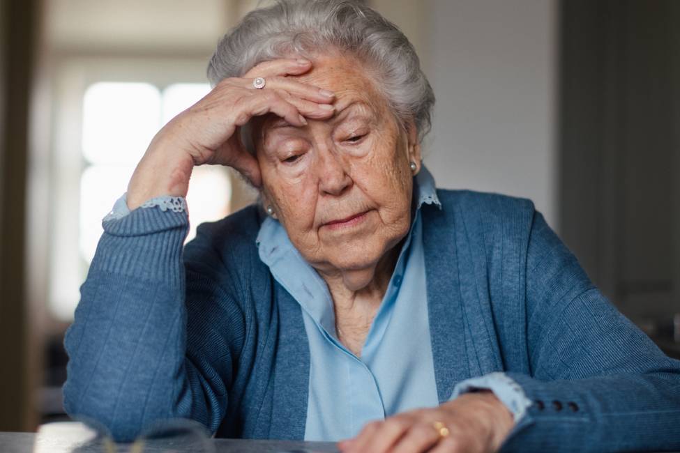 Senior woman counting her money at home.