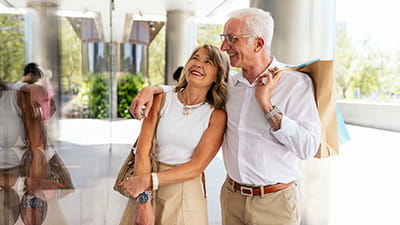 Happy senior couple carrying shopping bags and enjoying a day out together.