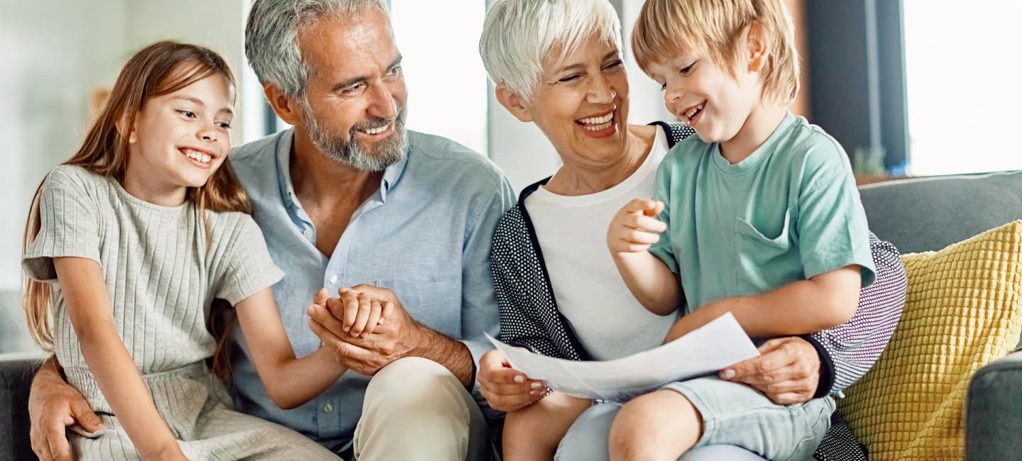 Portrait of grandparents and grandchildren having fun together at home