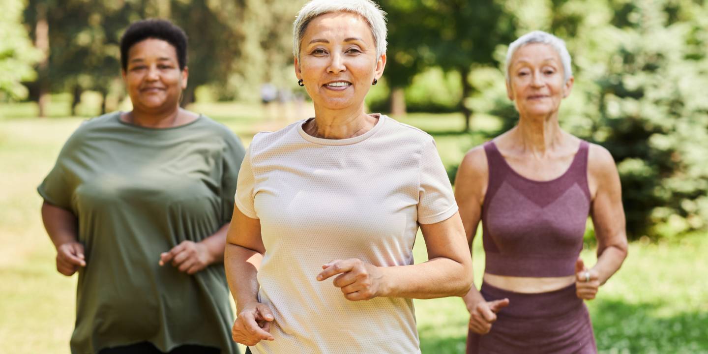 Portrait of active senior women running towards camera outdoors and enjoying sports