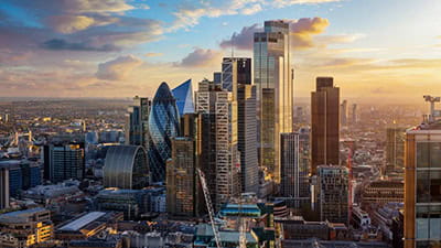 Elevated view of the City of London with the financial skyscrapers and Tower Bridge in the background during golden sunset time
