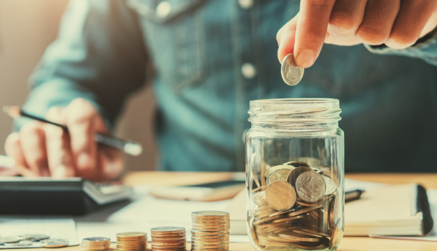 Man placing coins in jar