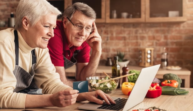 A couple staring at a laptop
