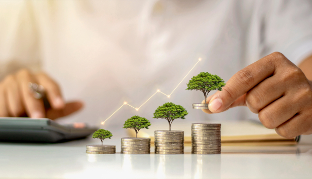 A stack of coins with tiny trees on them