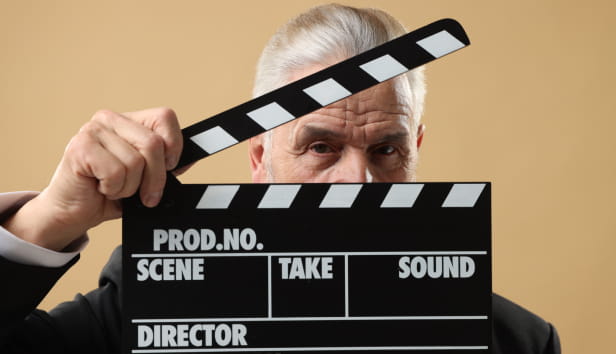 A man holding a clapperboard