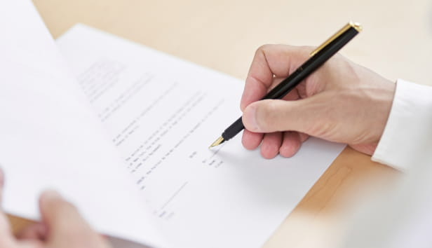 A person signing an official document
