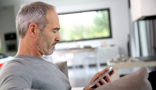 A man looking at his phone in his hand