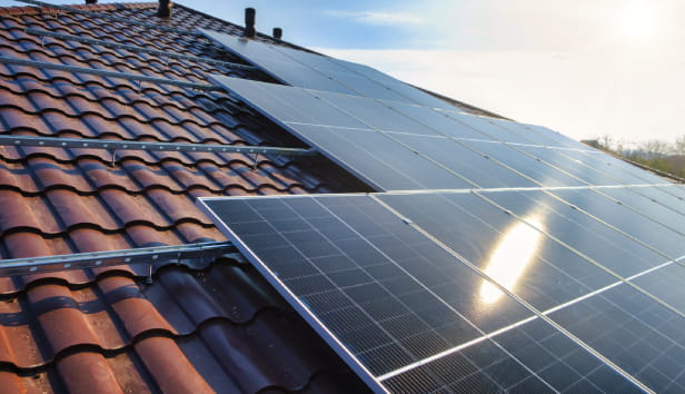 Photovoltaic panels on the roof . Roof Of Solar Panels. View of solar panels (solar cell) in the roof house with sunlight
