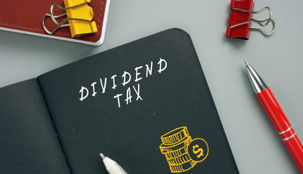 Business concept meaning DIVIDEND TAX with inscription on the page. A dividend tax is a tax imposed by a jurisdiction on dividends paid by a corporation to its shareholders.