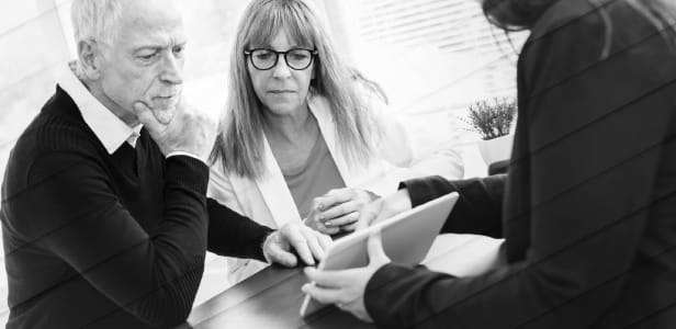 Senior couple meeting financial adviser for investment, geometric pattern