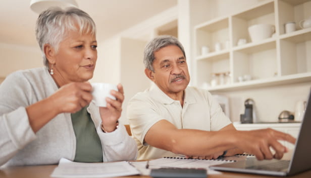 Senior couple, budget and laptop in home for planning loan, investment or financial administration. Man, woman and finance at computer for retirement, savings and banking of insurance, pension or tax