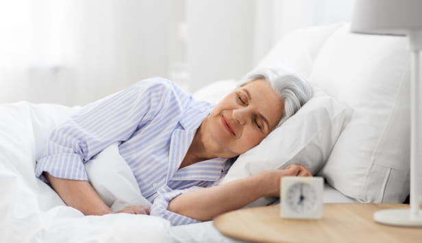 old age and people concept - senior woman sleeping in bed at home bedroom