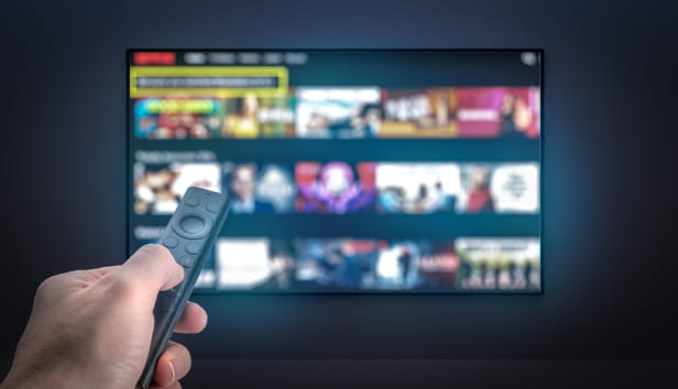 Streaming service. TV screen with lot of pictures and hand holding TV remote control. Multimedia Television video streaming, Media TV on demand. Subscription Streaming video