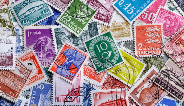 Postage stamps.A collection of world stamps in a pile.Postage stamps from different countries and times