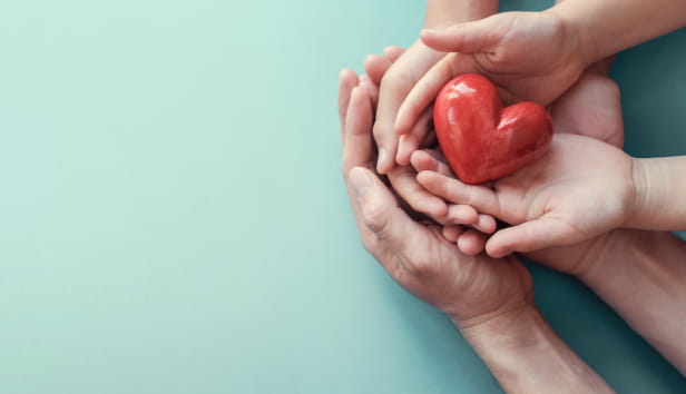 Family hands holding red heart, heart health insurance, organ donation, happy volunteer charity, CSR social responsibility,world heart day, world health day,world mental health day,foster home concept