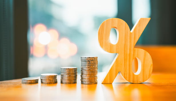 Percentage model with coins stack. Concepts of the banking system, rising interest rates, inflation, deflation, and savings.