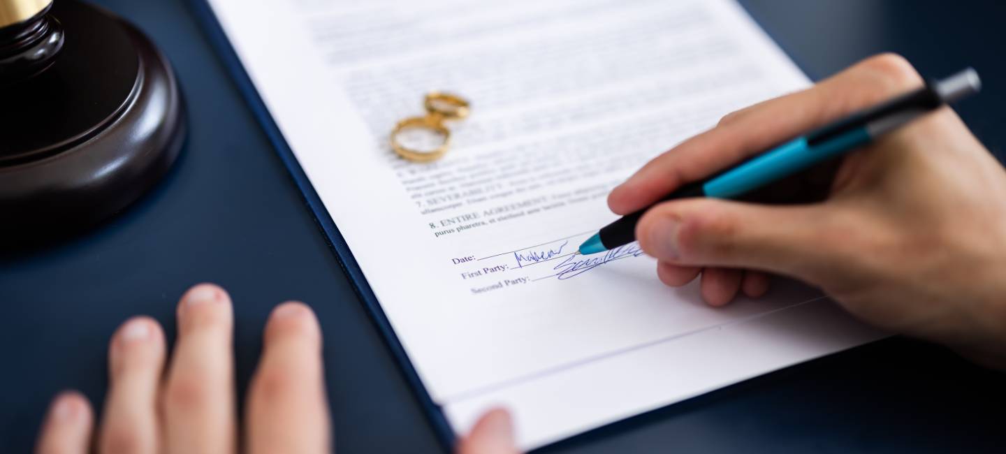 couple consulting with a lawyer in court to sign a divorce agreement document.