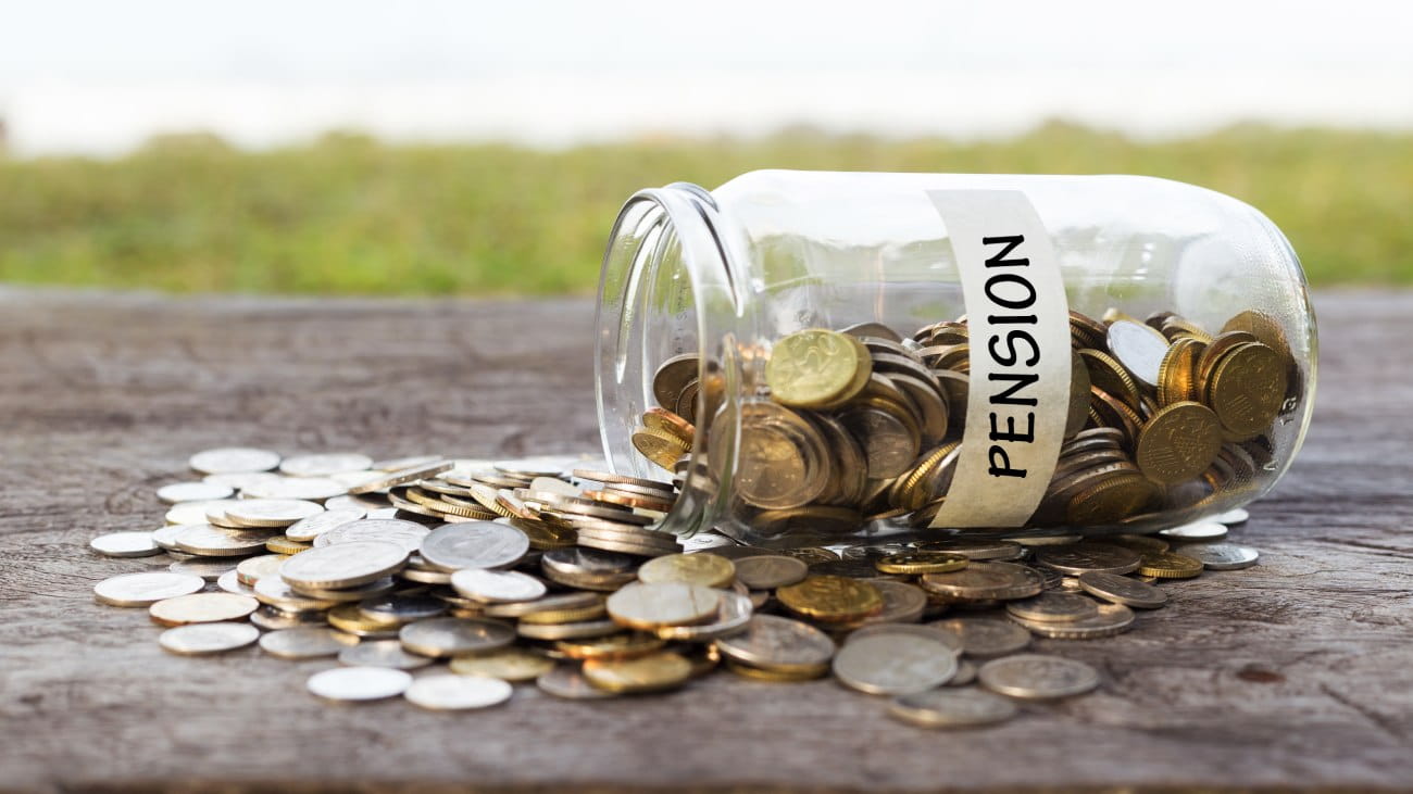 A glass labelled 'pensions' full of coins